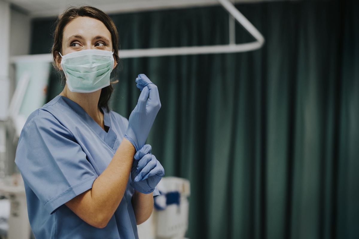 female-nurse-with-mask-putting-gloves.jpg
